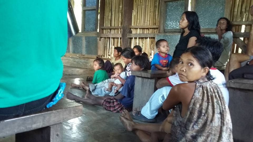 Villagers sitting in church